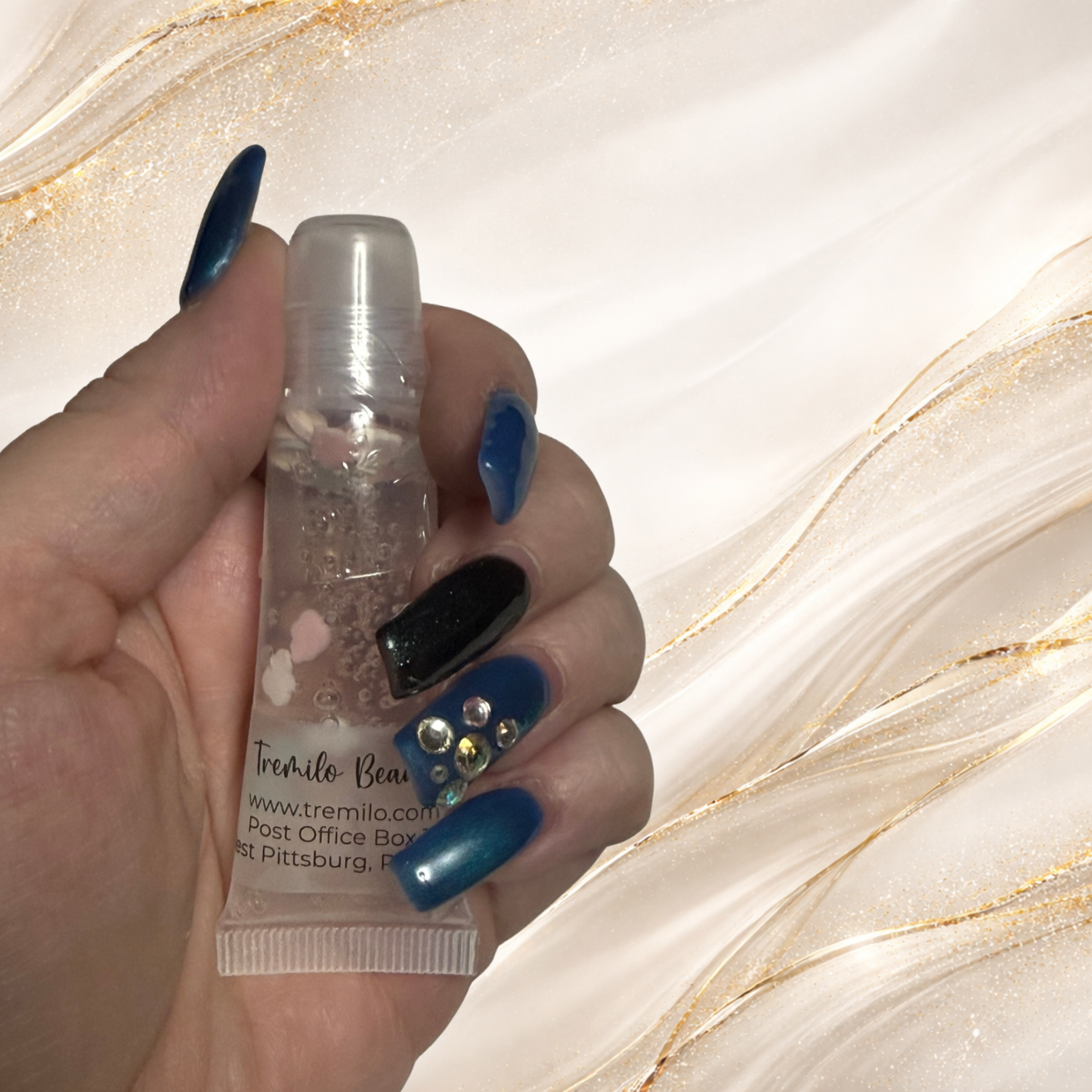 Hand holding Candy Cloud™ 10 ml squeeze tube showing pastel charms inside