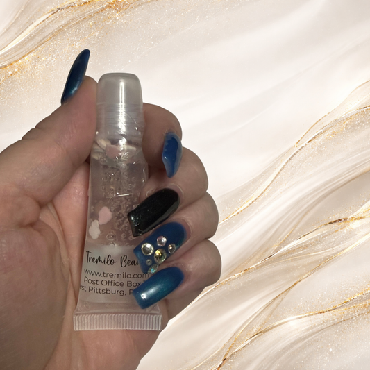 Hand holding Candy Cloud™ 10 ml squeeze tube showing pastel charms inside