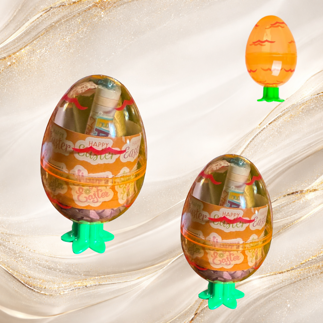Two carrot containers filled with Tremilo lip gloss, candy, and accessories, designed as reusable Easter basket stuffer gift sets