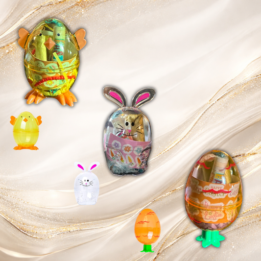 Assorted Tremilo Easter Bunny Gloss Sets in chick, bunny, and egg containers filled with lip gloss, bracelet, and Easter treats on neutral background