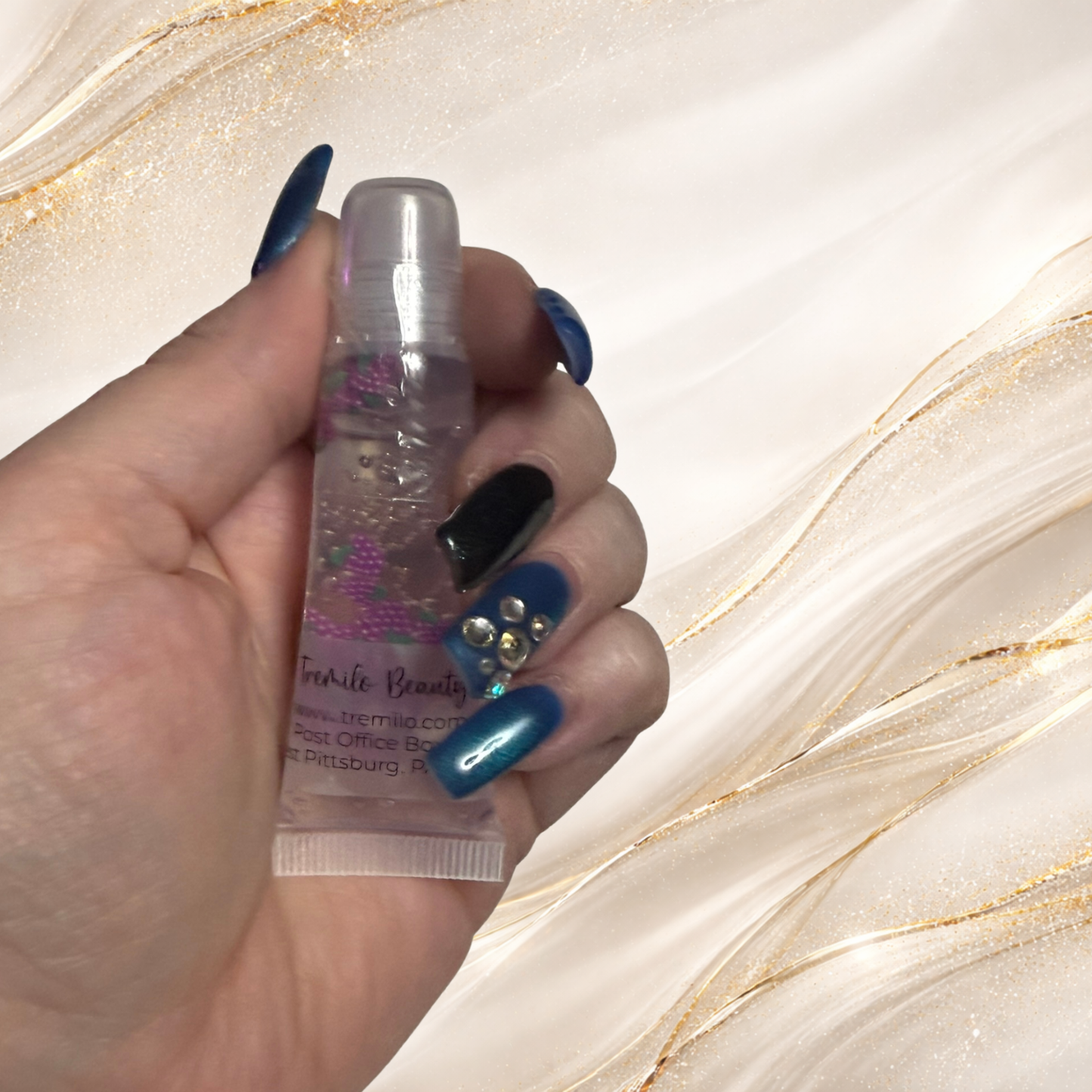 Berry Blend™ Jelly Lip Gloss in 10 ml squeeze tube held in hand with grape charms