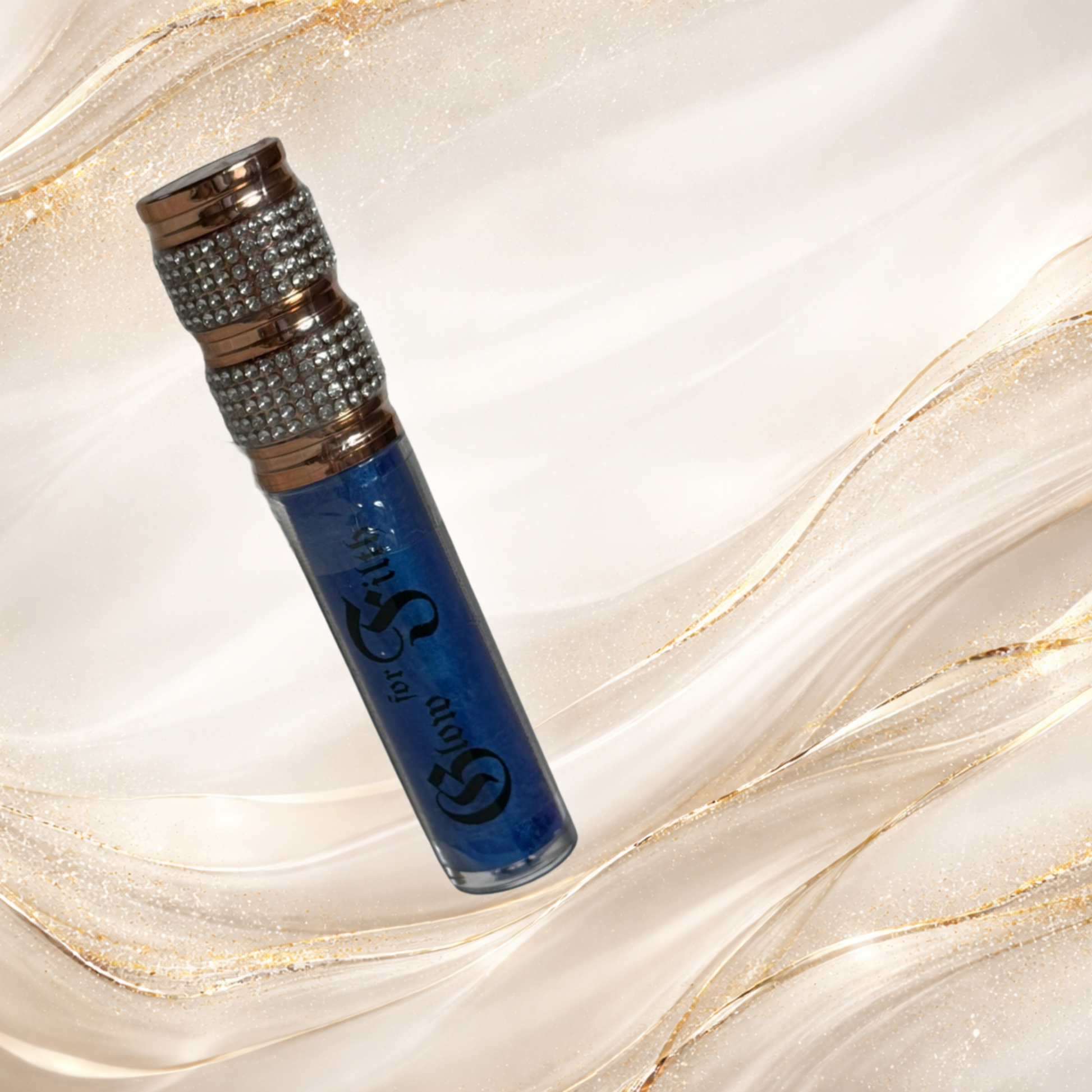 Blue Alchemy lip gloss by Tremilo Beauty featuring deep sapphire blue shimmer gloss in a clear tube with rhinestone cap.