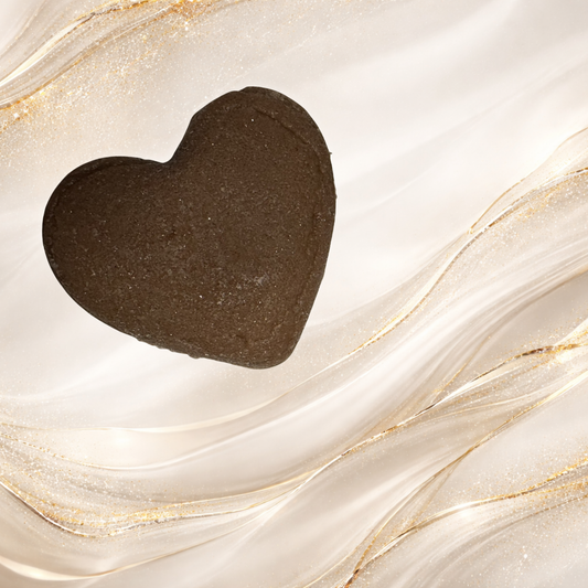 Heart-shaped chocolate bath melt made with cocoa butter designed to soften skin and add moisture during a warm bath.