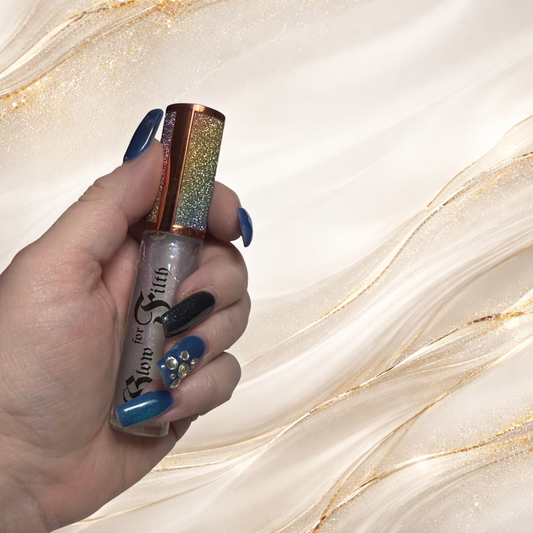 Faegasm™ iridescent shimmer lip gloss held in hand showing multidimensional sparkle by Glow for Filth.