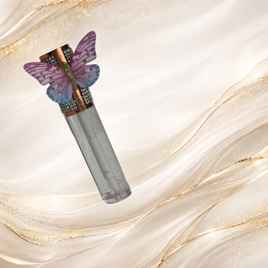 Flutterlight clear lip gloss with butterfly charm cap and floating star glitter – Tremilo Beauty.