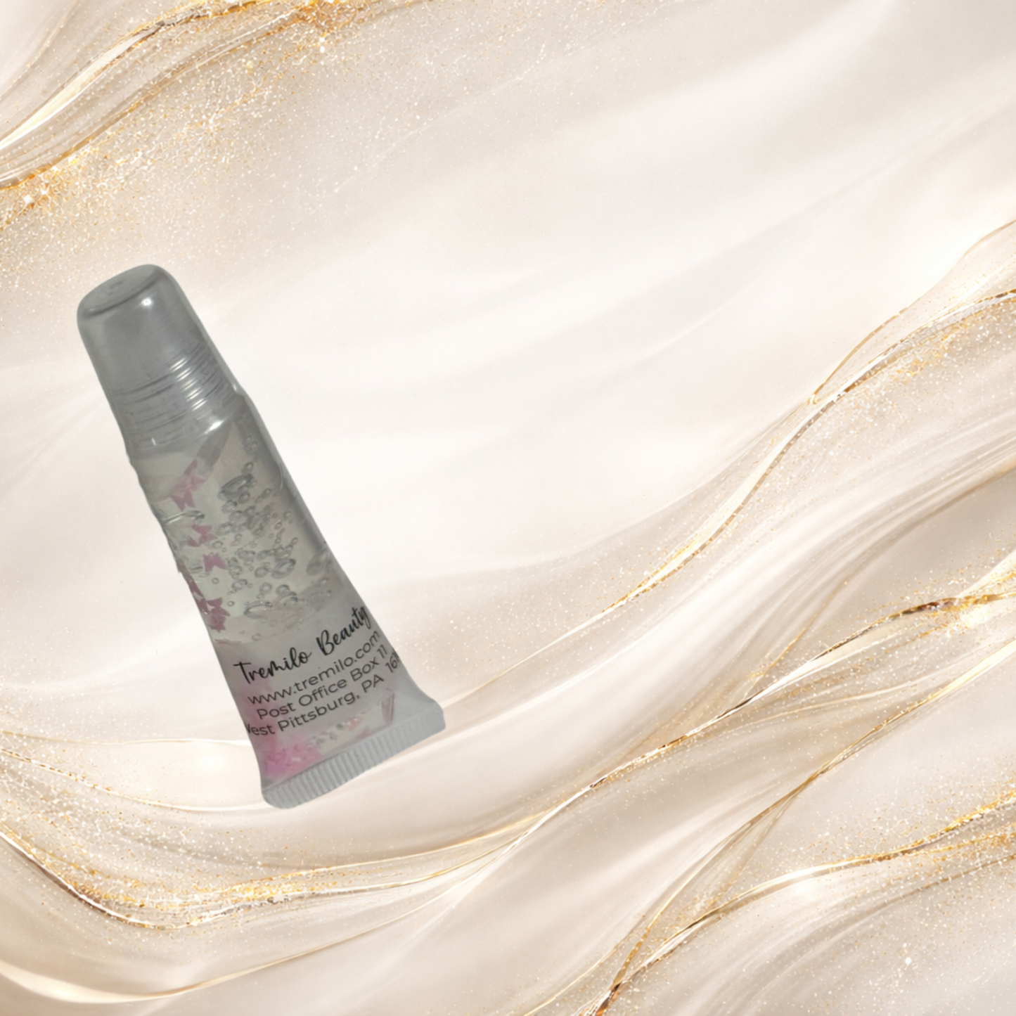 Flutterlight Gloss™ 10 ml squeeze tube with crystal-clear gloss and butterfly accents