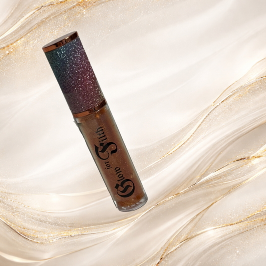 GILTTRIP™ gold shimmer lip gloss tube with luminous metallic sparkle and high-shine finish by Glow for Filth.