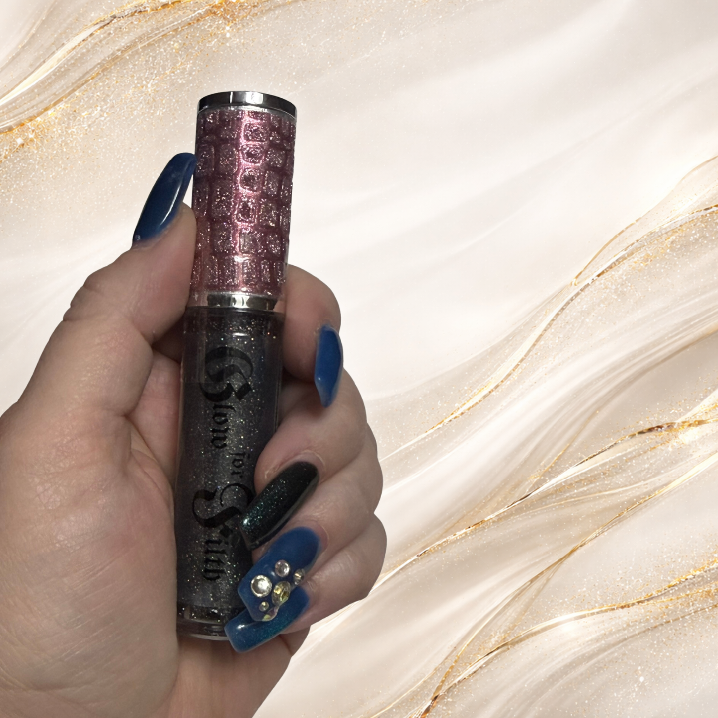 GLITCHEZ™ black holographic lip gloss held in hand showing multidimensional shimmer and sparkle by Glow for Filth.