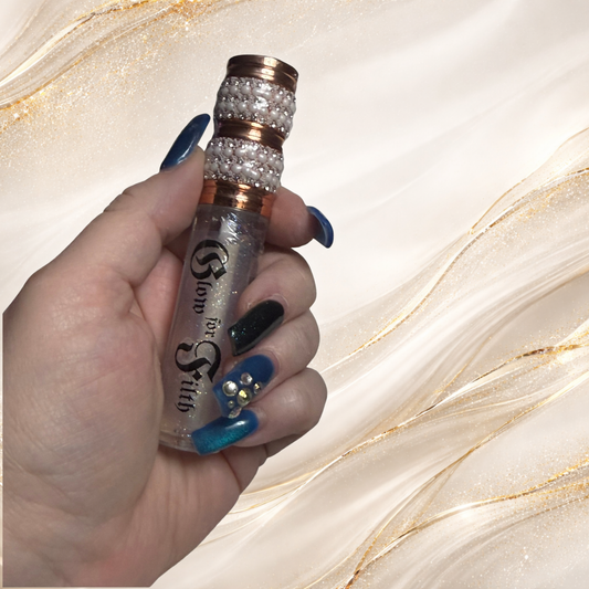 Hand holding Prisma Void Glam rainbow shimmer lip gloss from Glow for Filth with multidimensional sparkle