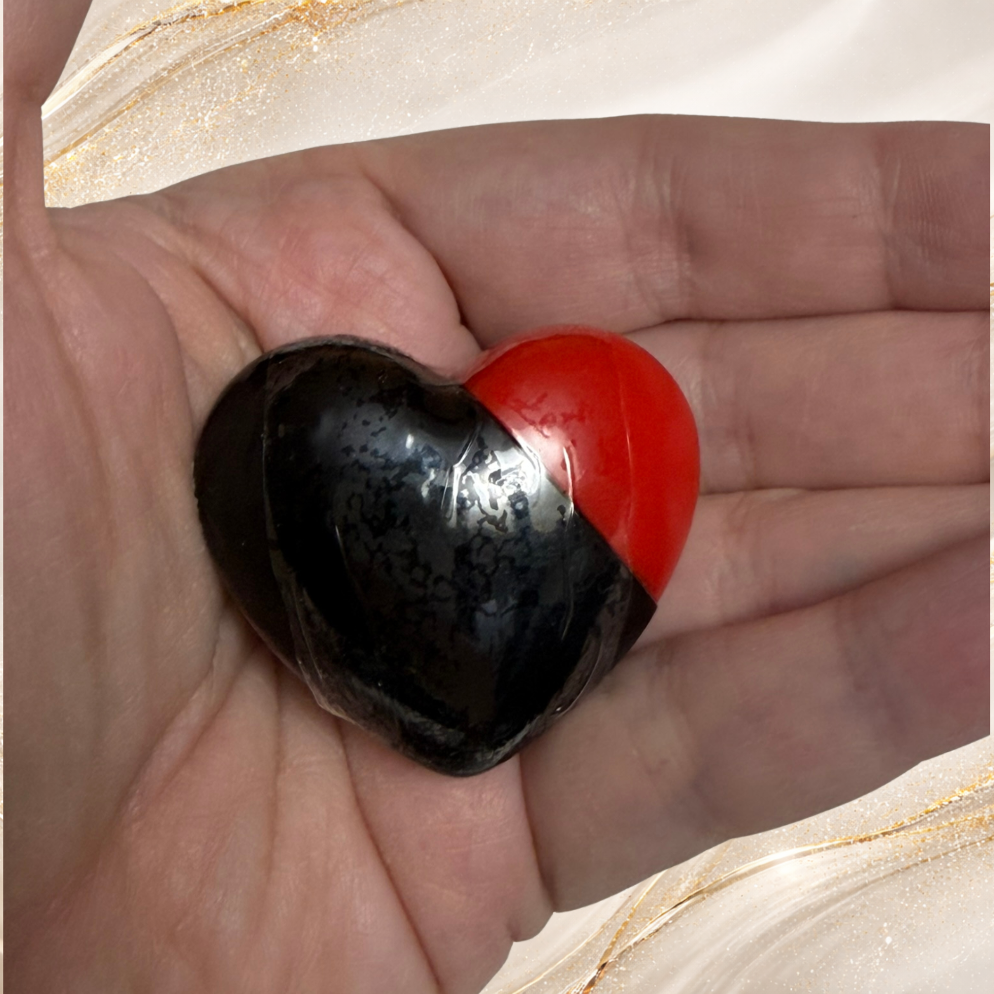 Iron City Ink black lip gloss in heart shaped tube held in hand from Tremilo Steel City Gloss Collection