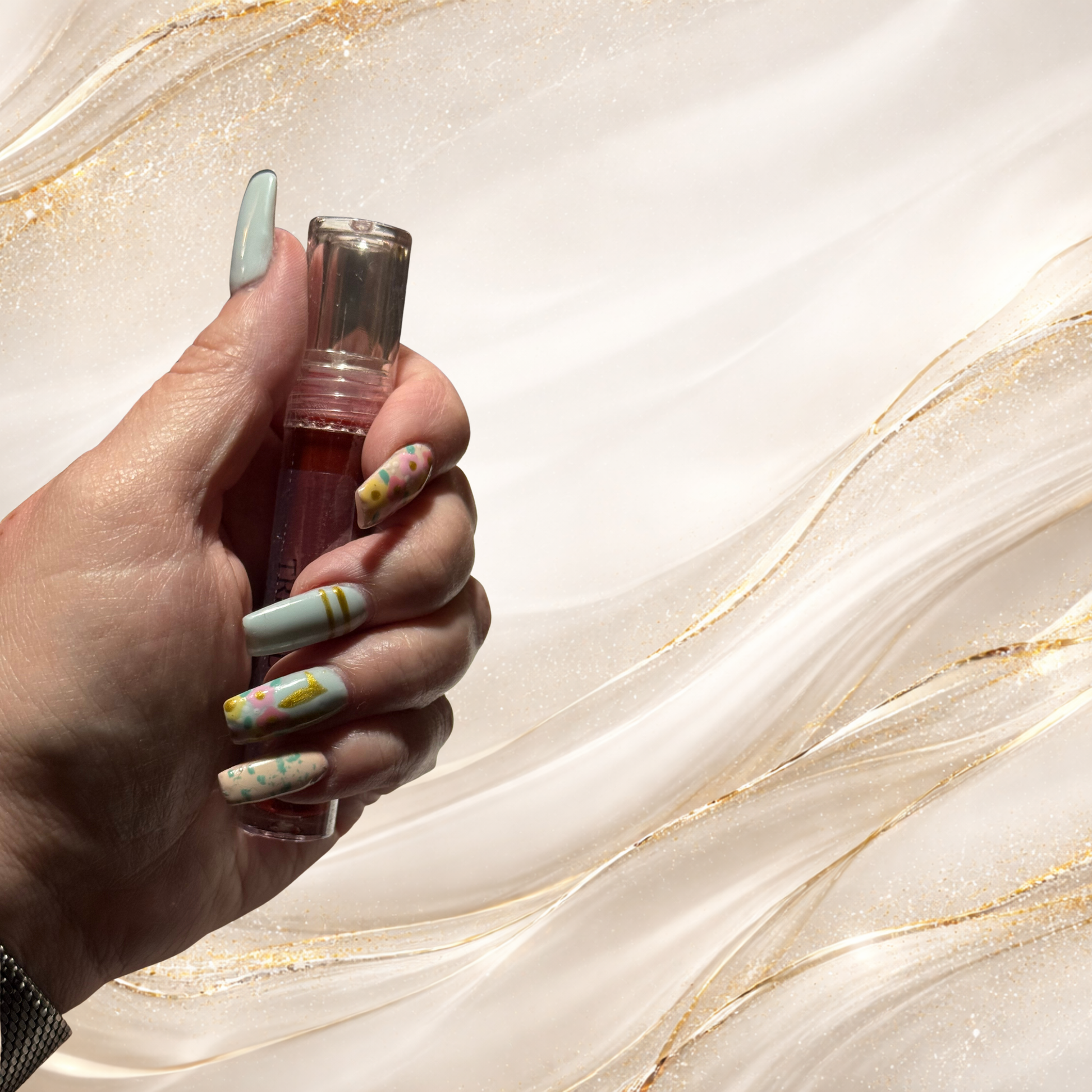 Mourningwould lip gloss by Tremilo held in hand showing rich red shade and high shine finish