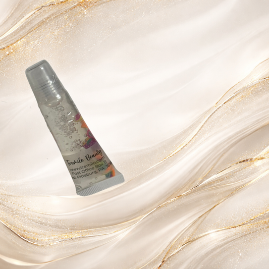 Paradise Fruit™ Tremilo lip gloss in a clear 10 ml squeeze tube with floating fruit slice charms on a neutral background