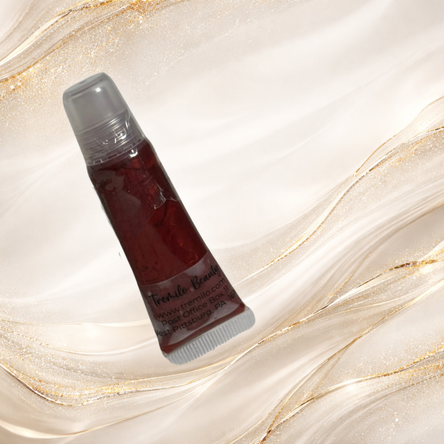 Steelheart red lip gloss in clear squeeze tube packaging from the Tremilo Steel City Gloss Collection.  