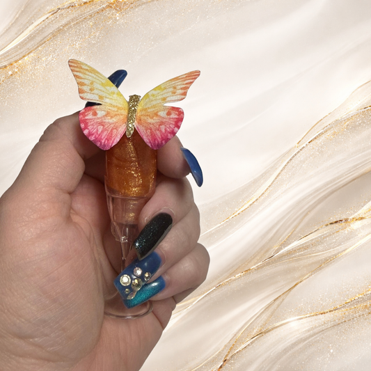 Champagne Kiss pH color-changing lip gloss in champagne glass tube held in hand