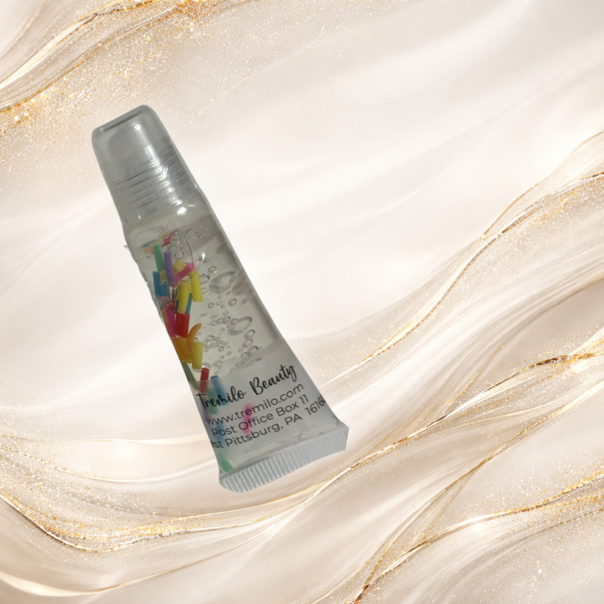 Tremilo Island Confetti lip gloss squeeze tube with floating rainbow sprinkle confetti in clear jelly gloss