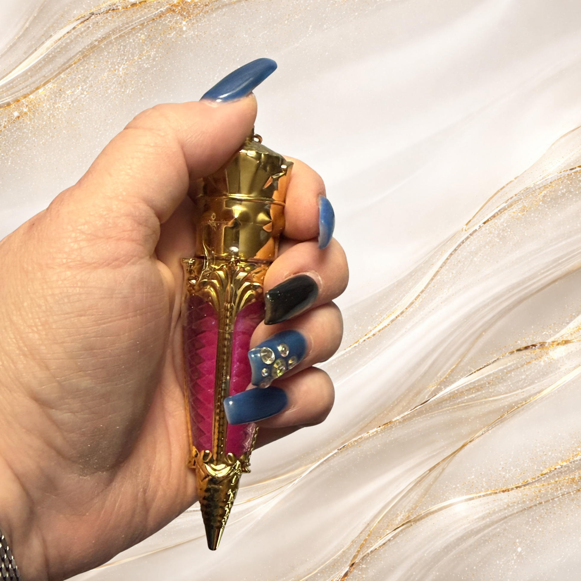 Tremilo South Side Pop lip gloss held in ornate gold claw tube with vibrant pink shimmer gloss