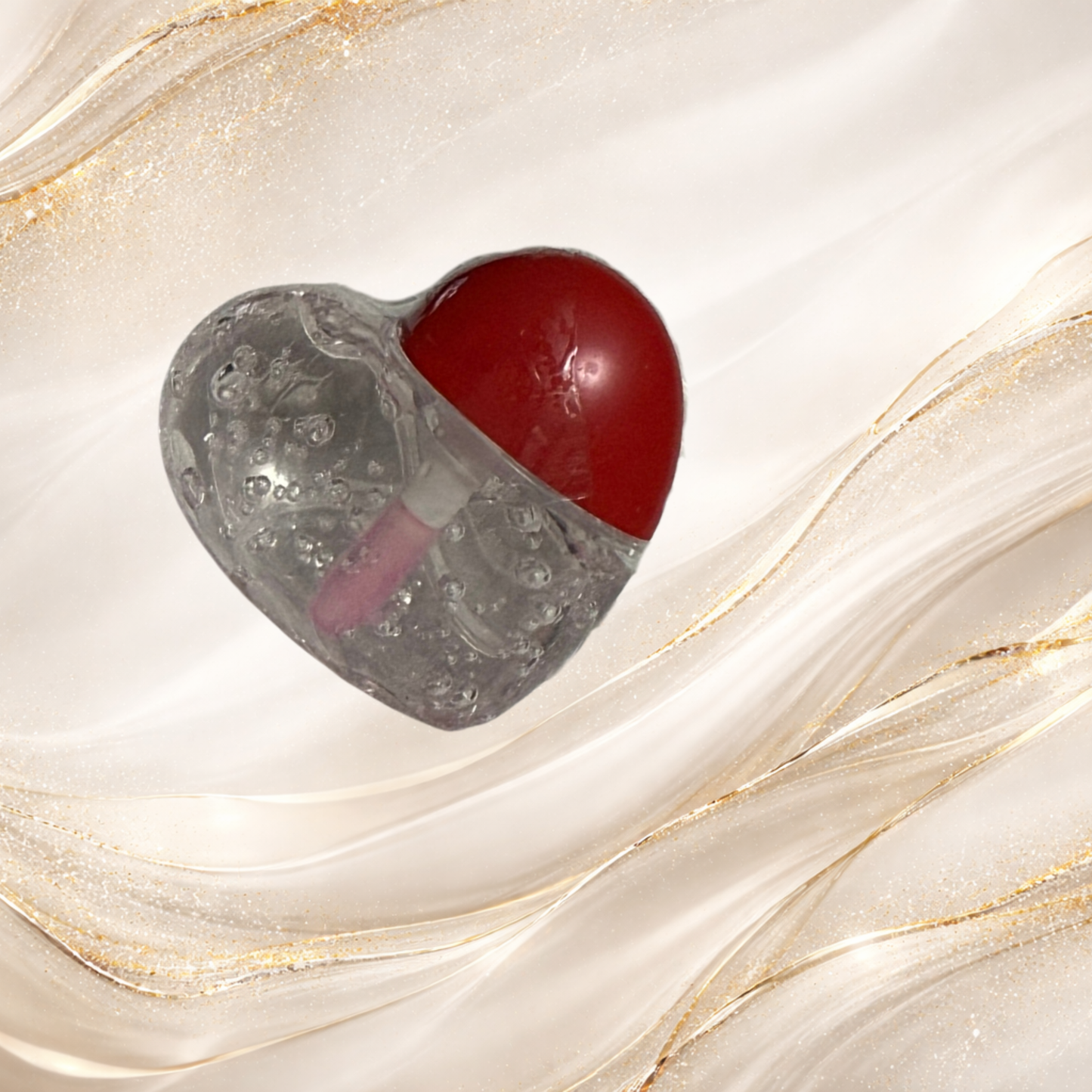 Steel Chemistry heart-shaped lip gloss from Tremilo Beauty with clear gloss, bubble texture, and red heart cap packaging