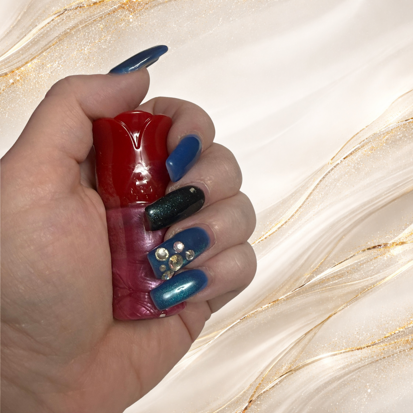 Three Rivers Rose lip gloss from Tremilo Beauty held in hand in red rose shaped tube with rose pink shimmer gloss