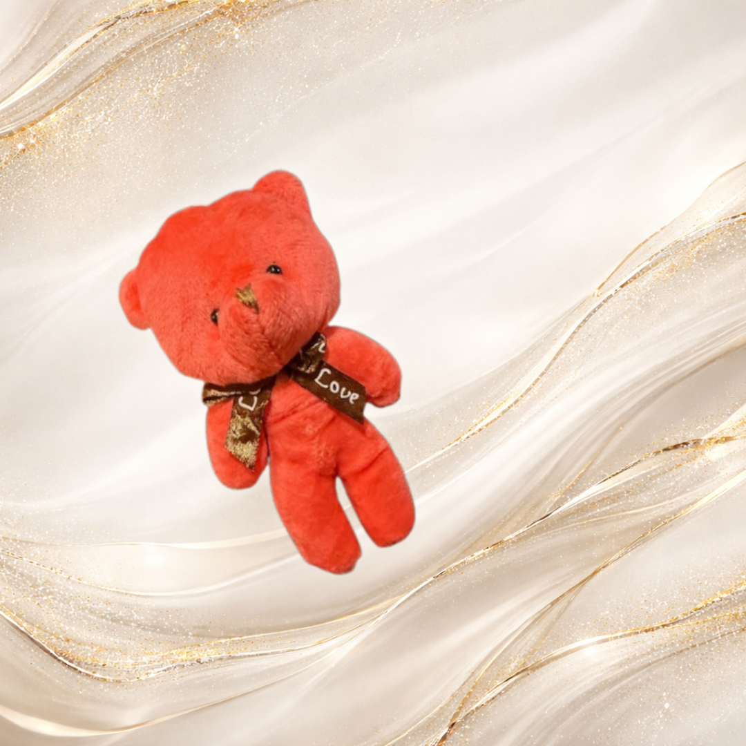 deep red teddy bear charm with decorative ribbon